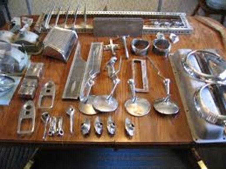 Various car chrome parts on wood table