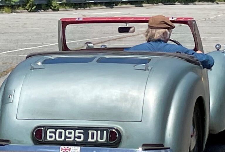 Silver British car from rear
