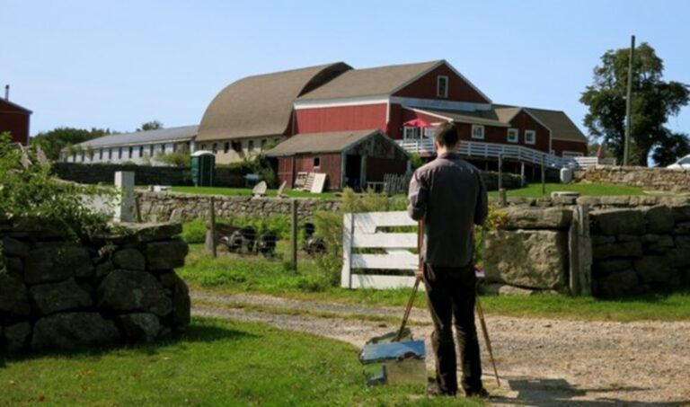Artist painting red barn