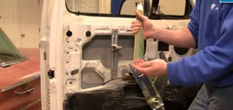 Man working on window regulator assembly