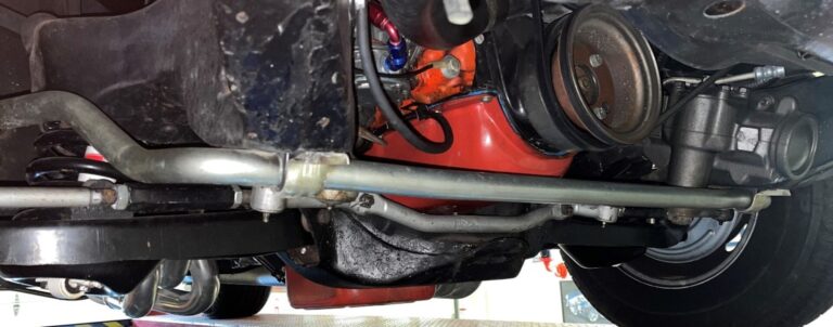 Chevrolet underside showing engine and car sway bar