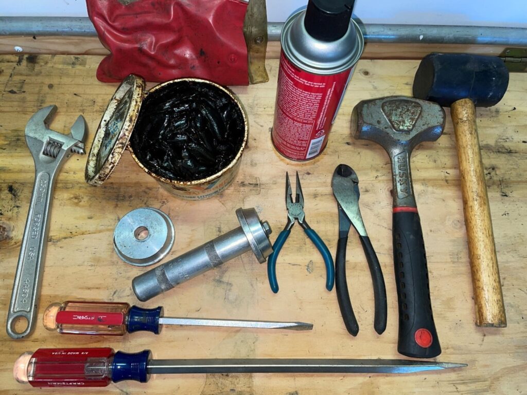 Tools layed out on work bench needed for wheel bearing work