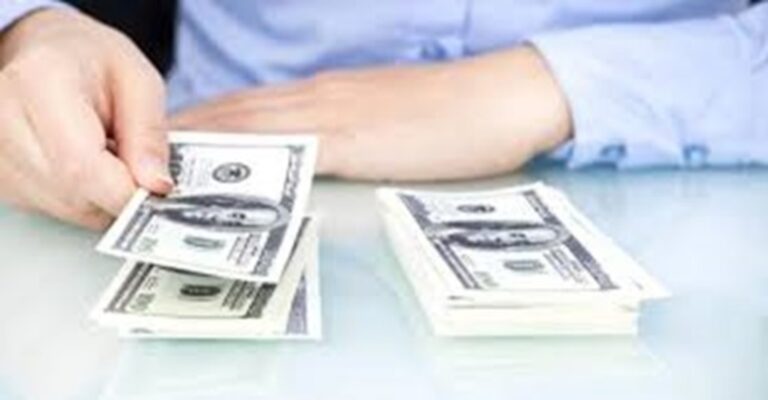 Man in blue shirt counting money