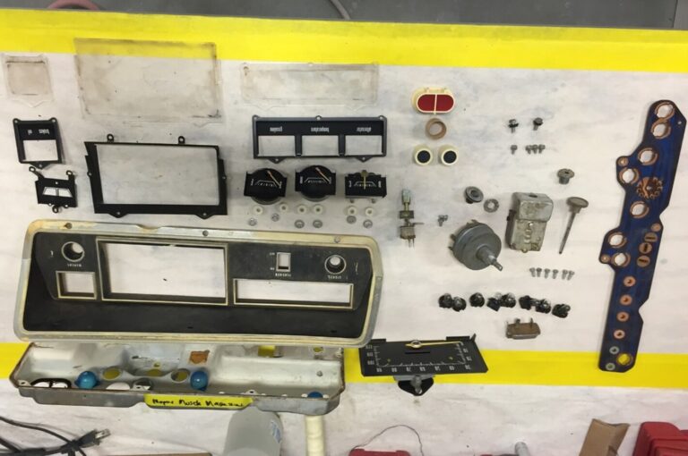 Disassembled classic car bezel and gauges