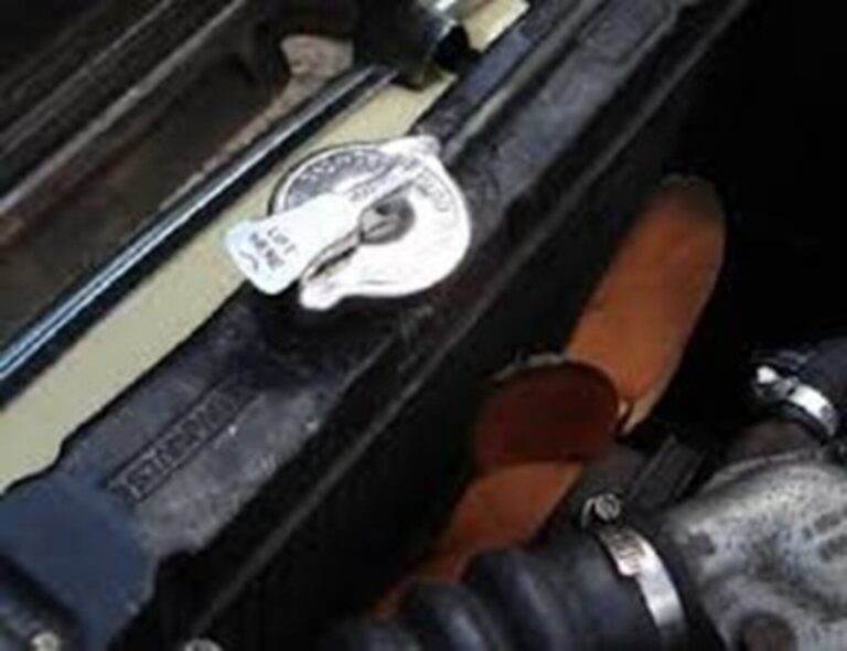 Lever style radiator cap installed on a classic car radiator