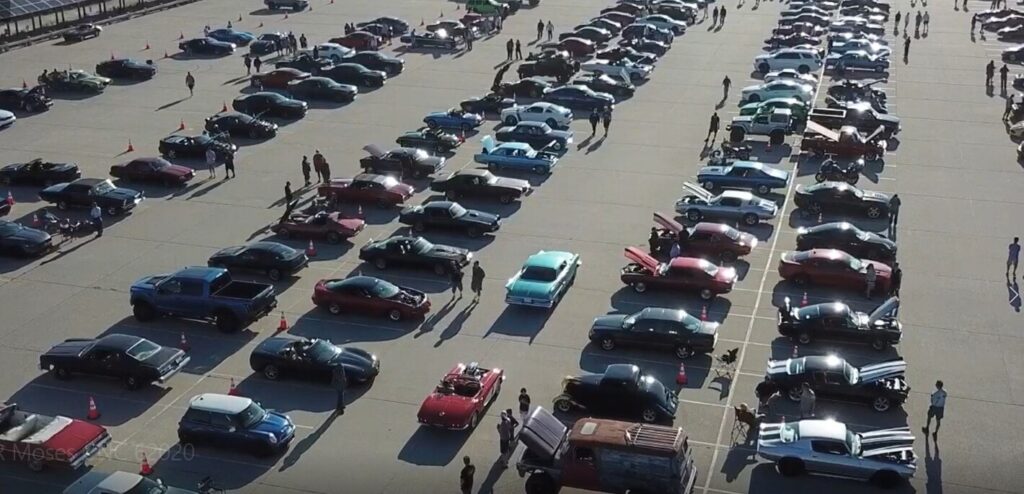Arial view of classic car show in the morning light