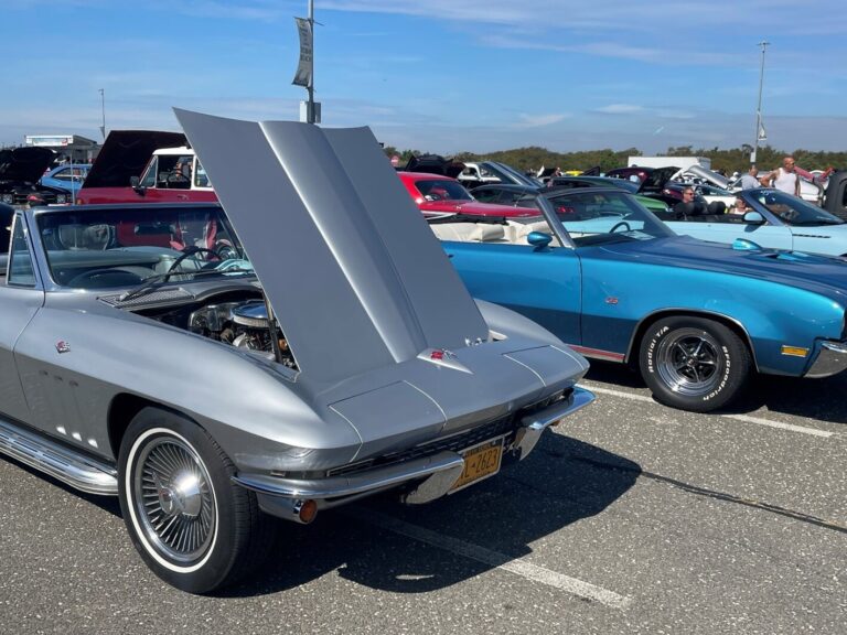 Silver 1965 Corvette wit hood open and Blue Buick GS