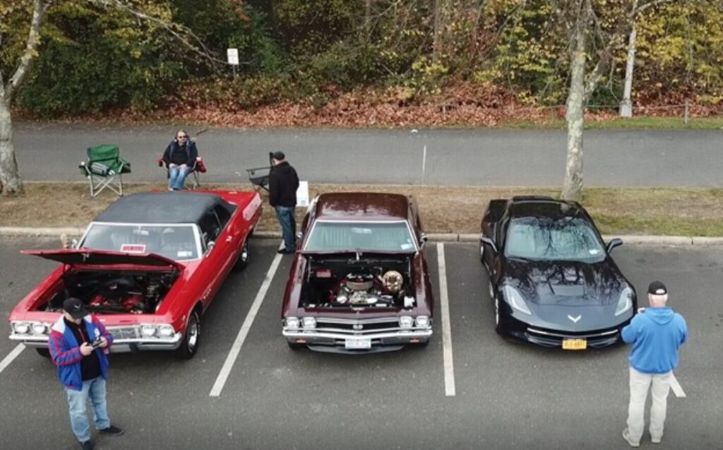 1965 Impala. 1968 Chevelle and 2015 Corvette parked at a car show in the fall
