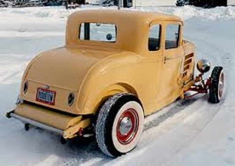 Yellow roadster driving on a snowy road