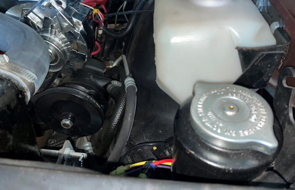 Power steering pump and reservoir on a 1960s Chevrolet