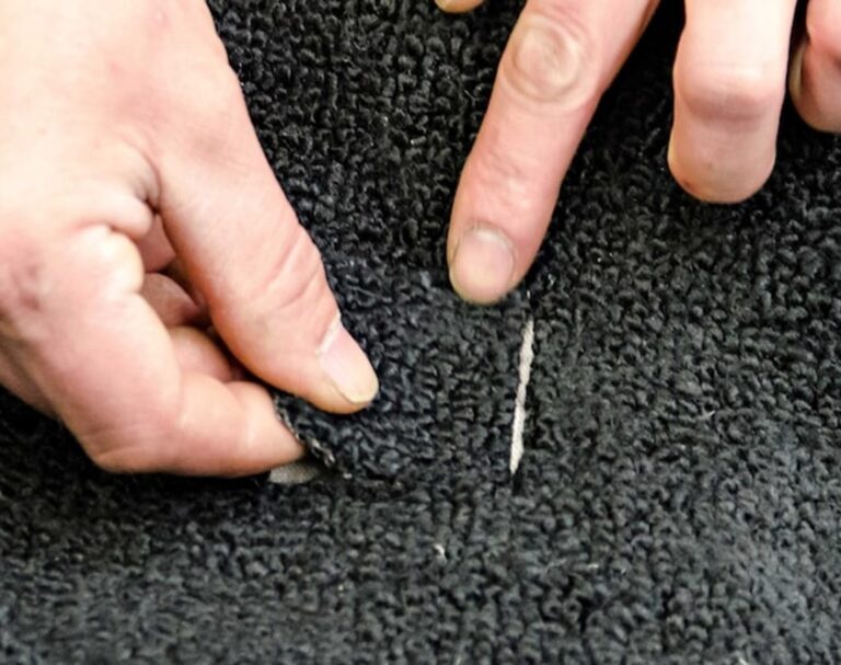 Placing the carpet patch in the cut out area of the car carpet
