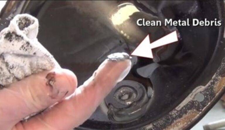 A person with metal debris from the rear differential on their finger