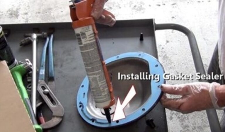 Installing gasket sealer onto a blue gasket attached to the rear differential cover