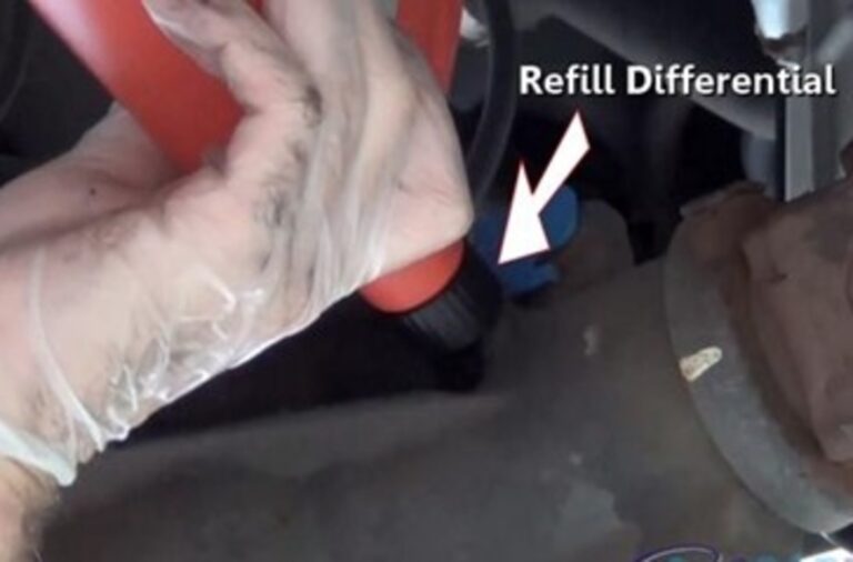Filling a rear differential with gear oil from a red container