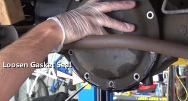 Loosening the rear differential cover with a pry bar