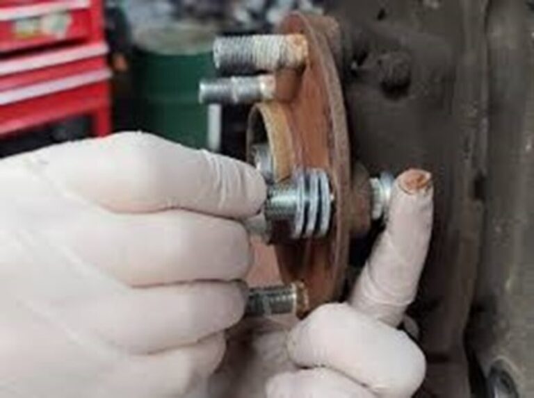 Using washers and bolt to tighten the wheel stud onto the wheel hub