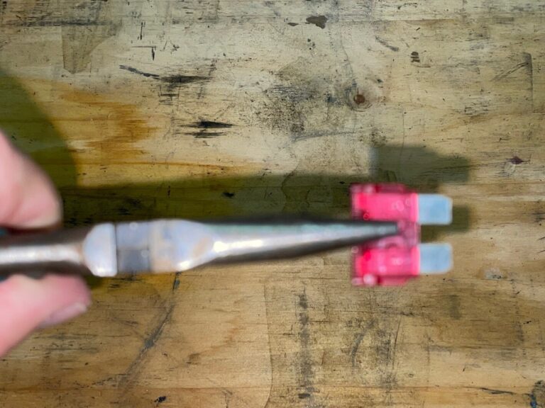 Holding a blade type car fuse with plyers