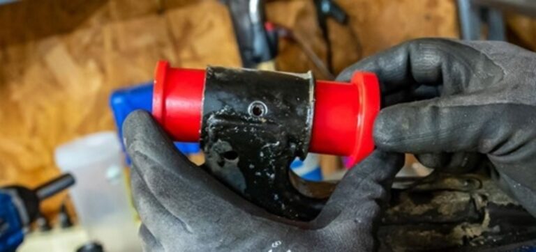 Holding 2 red poly suspension bushing on to a control arm