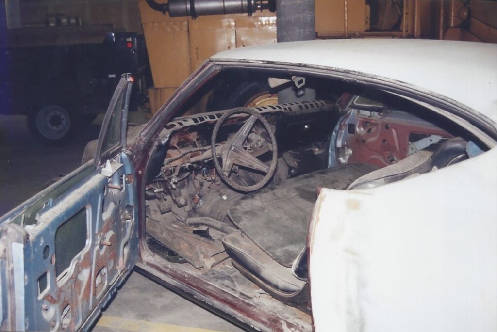A view of an unrestored 68 Chevrolet Chevelle with the door opened