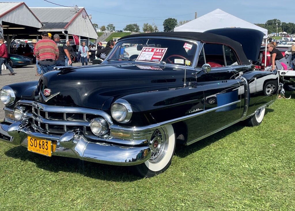 Vintage black Cadillac with a for sale sign