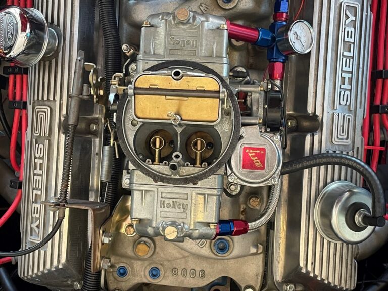 Overhead view of Ford engine with a silver Holley carburetor