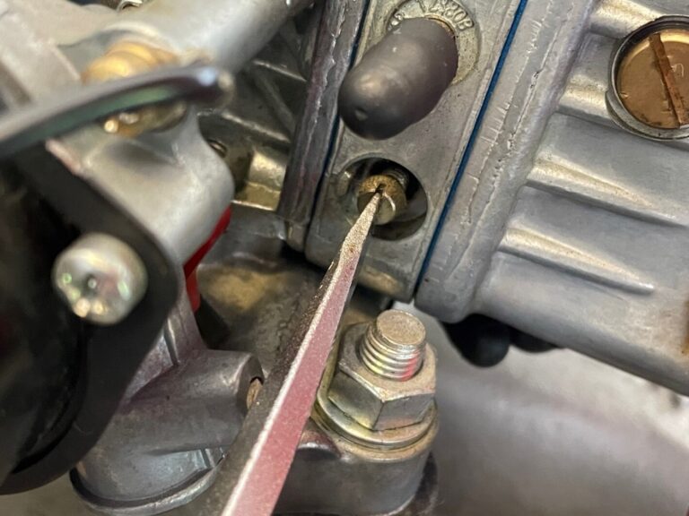 Adjusting a carburetor fuel mixture with a screwdriver