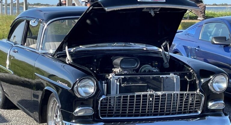 Hood oppen on a 55 Chevy showing it cooling system radiator and trans cooler