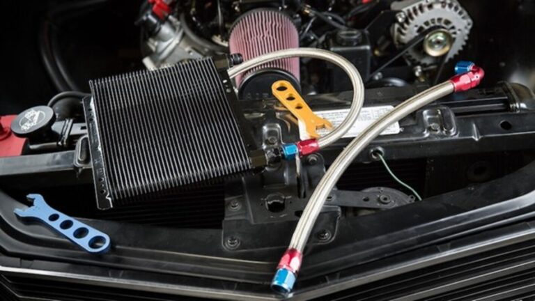 An engine oil cooling system being installed into a classic car