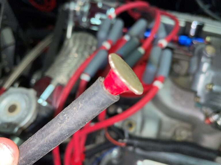 Using a red golf tee to plug a car vacuum hose