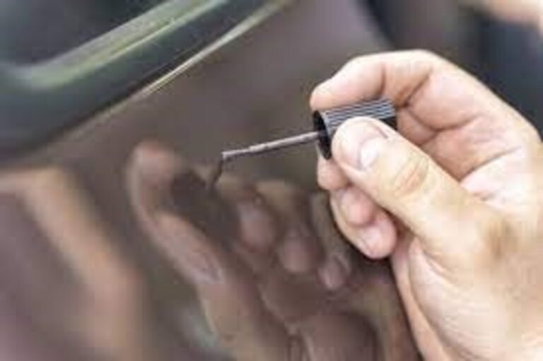 Paint touch-up using a brush on a car side panel
