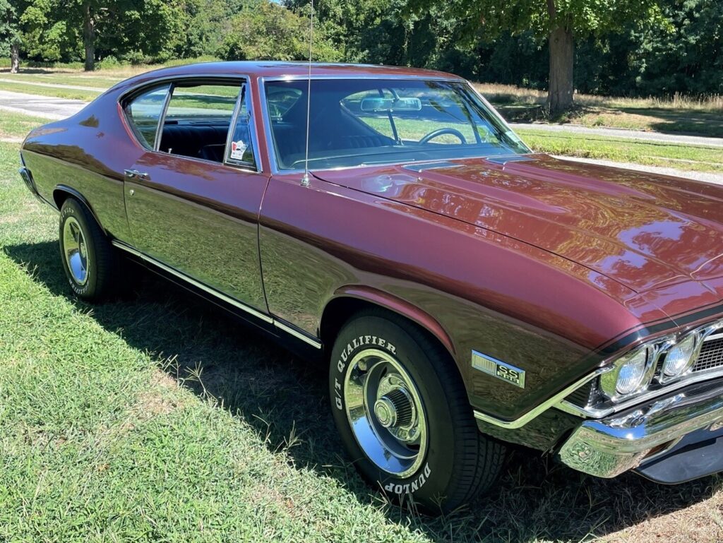 Great photo of a maroon Chevy Chevelle in a green field