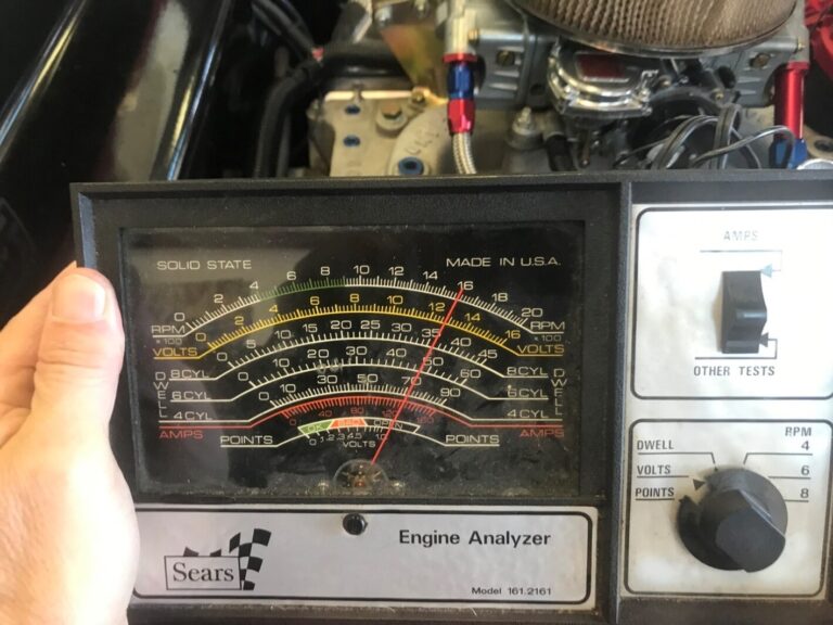 Volt meter reading a car battery at 12.5-volts
