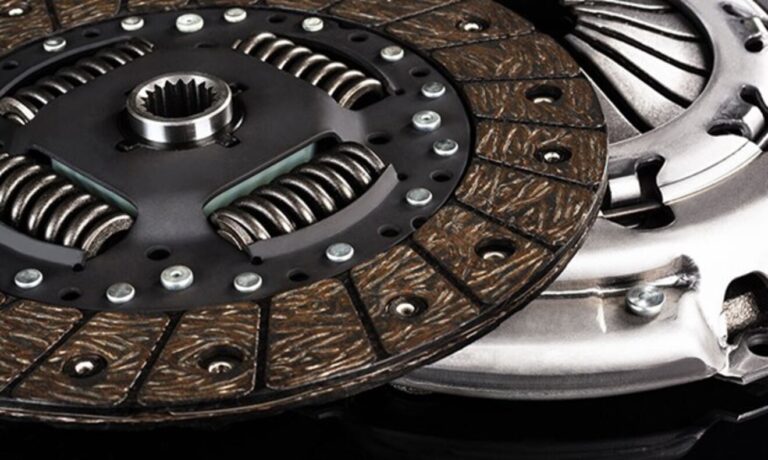 A new clutch disc sitting on top of a pressure plate from a clutch assembly