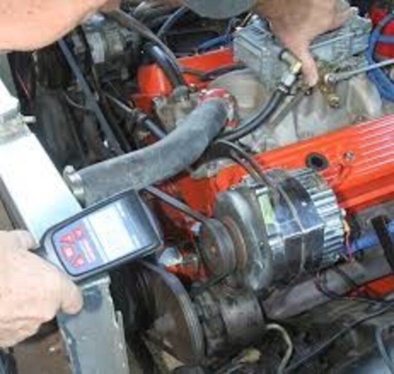 Mechanic using a timing light to adjust the car engine ignition timing