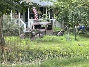 Rusting Chevy truck sitting in a front yard