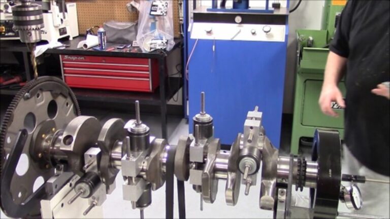 A car engine crankshaft on a balancing machine as part of the engine rebuilding process
