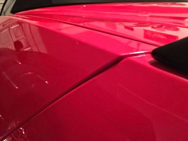 Spotting bad bodywork with misaligned body panels on a red car