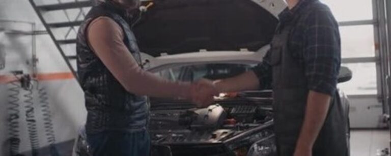 A mechanic in overalls shaking hands with a customer-understanding scammer methods
