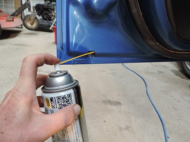Using an aerosol can to apply rustproofing into car door panel