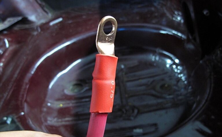 A red wire stripped with eyelet installed with protective cover for a battery relocation