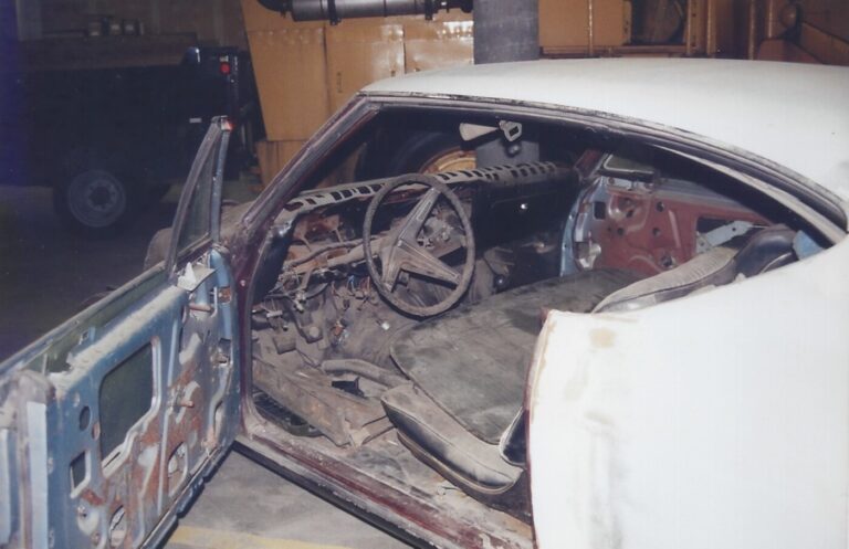 68 Chevy Chevelle before restoration in body primer and interior in pieces without a dashboard in need of car restoration planning