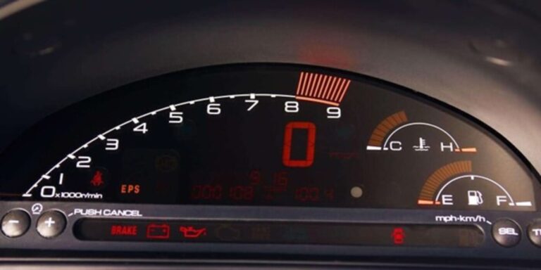 A digital gauge cluster with speedometer, tach, temp and fuel gauges
