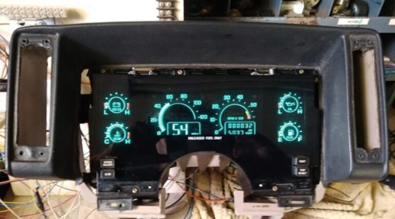 A digital gauge cluster being tested on a work-bench