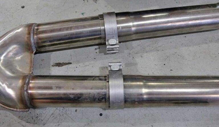 A dual chrome exhaust with t-bolt clamps installed on both exhaust pipes after the Y fitting