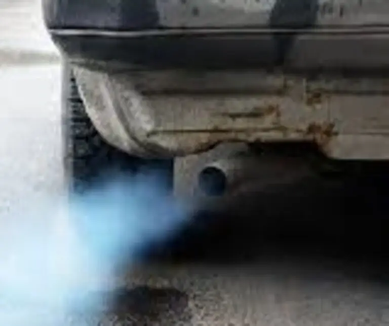 Car blowing blue smoke from exhaust