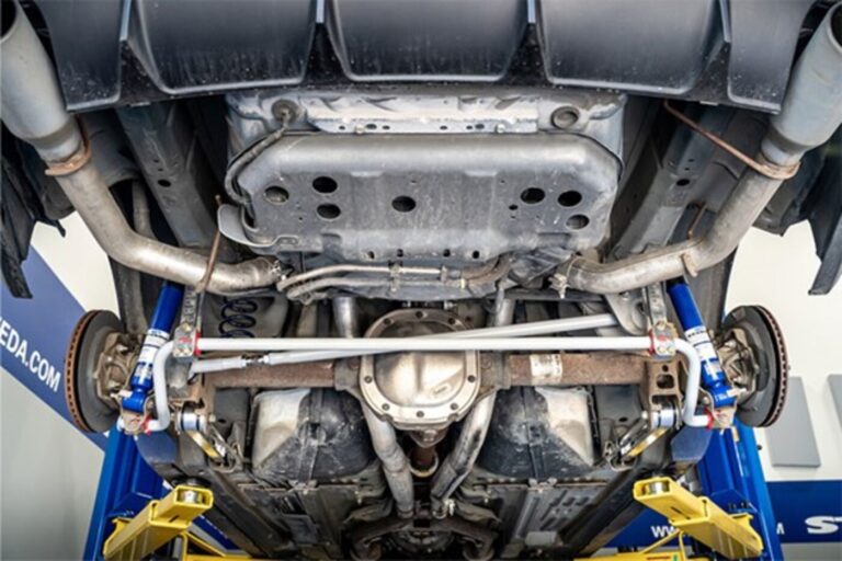 A GM 10-bolt GM rear axels with chrome differential cover mounted with racing suspension components.