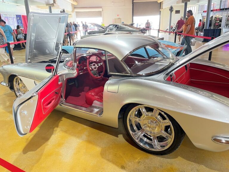 A silver custom Corvette on display at a car auction