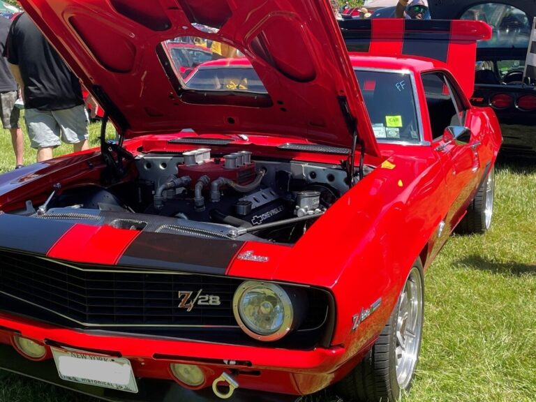 A red with black stripes 1969 Chevrolet Camaro withe modified engine showing how to modify your classic car