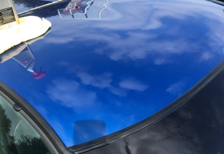 The roof of a blue Corvette after car polishing work has been started