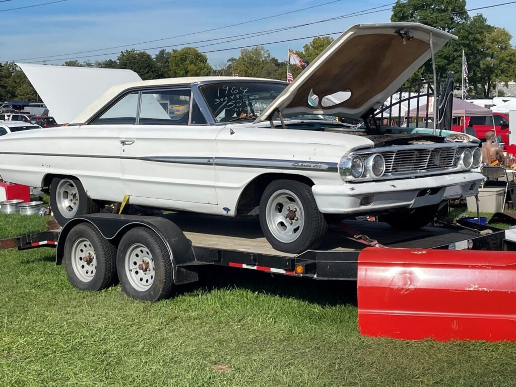 A white Ford Galaxie light-weight on a trailer before starting a car restoration